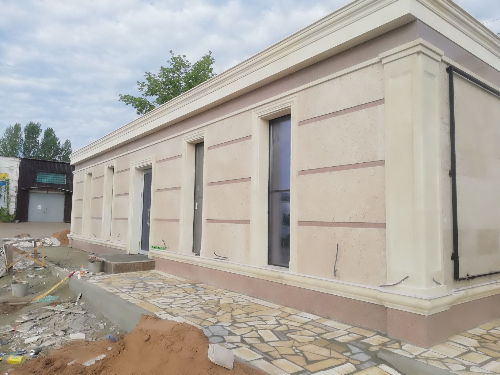 Облицовка фасада травертином и гранитом