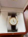 Золотые часы с бриллиантами OMEGA.