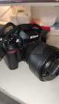 Камера Nikon D7000 с объективом