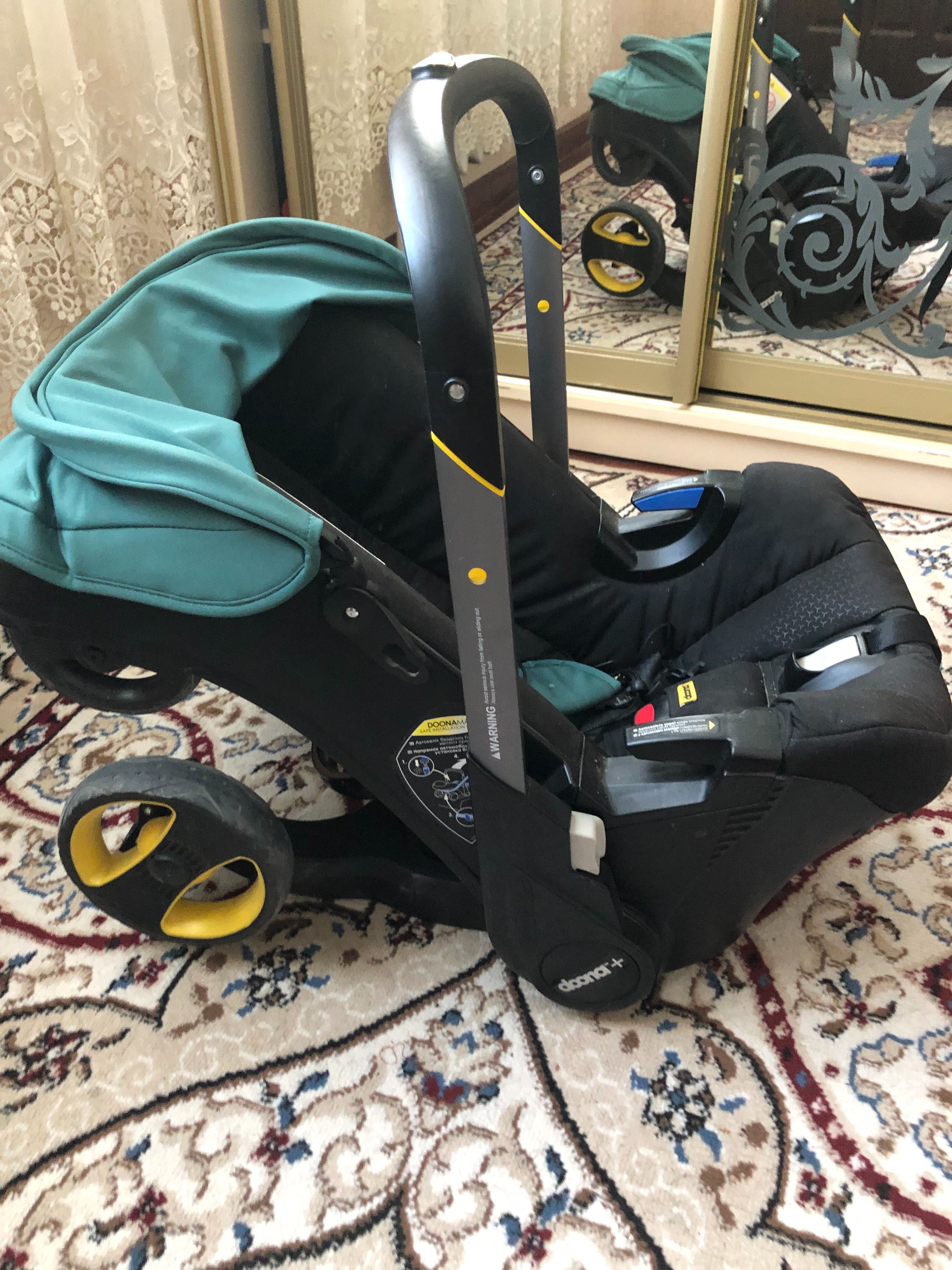 KaspiRED. Коляска-автокресло SimpleParentingDoona+™ цвет Racing Green.