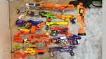Коллекция бластеров NERF разных поколений цена на фотографиях