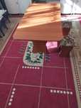 Кухонный стол со стульями и кровать