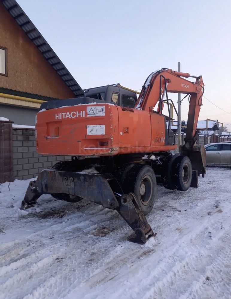 Услуги по разрытию котлованов и трпншей эксковатором колесным cat